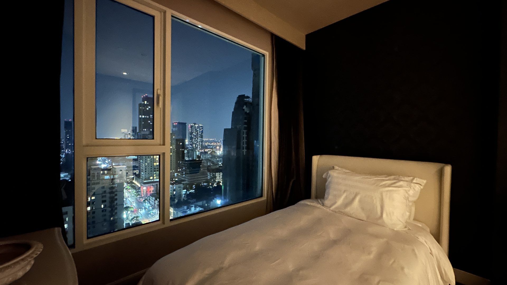 Bedroom at night with city lights